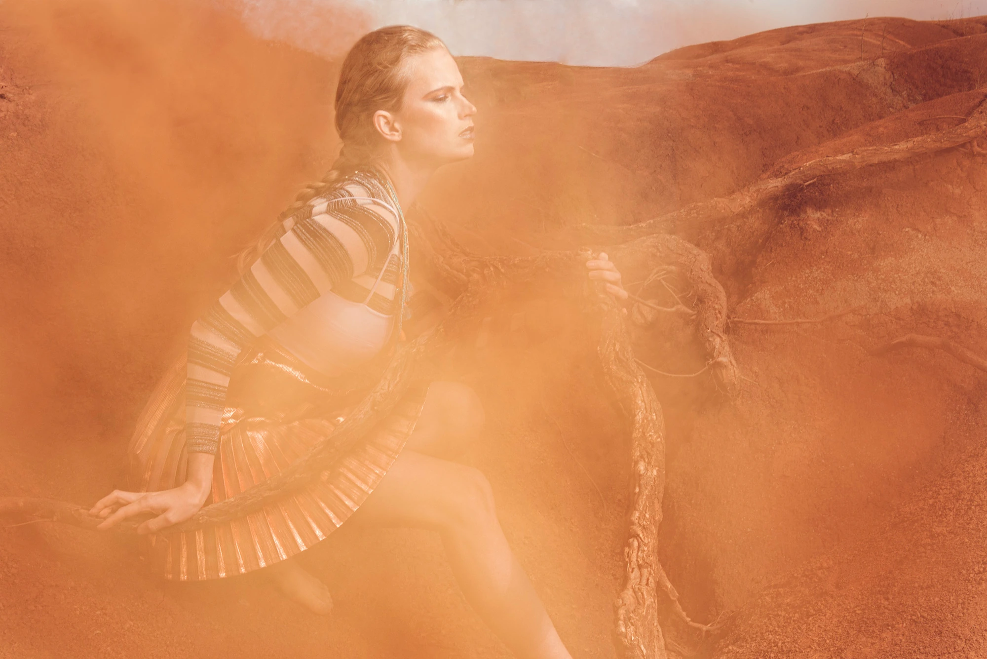 Atmospheric fashion image with golden dust and dramatic styling
